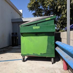 Green Dumpster at a Gas Station